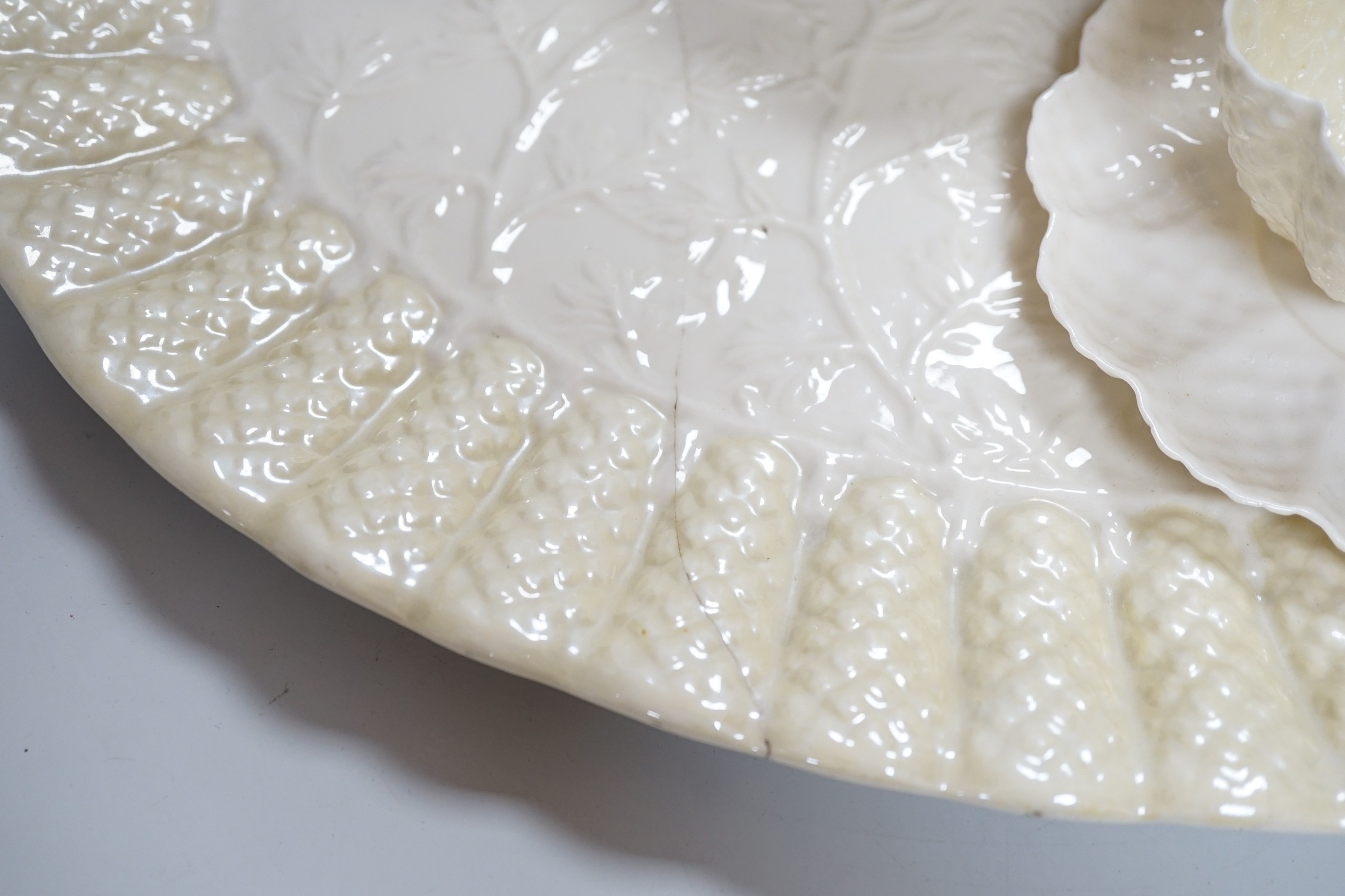 A Belleek porcelain teaset comprising tray, teapot, milk jug, sugar bowl, four cups and four saucers